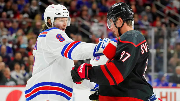 Feb 21, 2020; Raleigh, North Carolina, USA;  Carolina Hurricanes right wing Andrei Svechnikov (37) and New York Rangers defenseman Jacob Trouba (8) battle during the second period at PNC Arena.